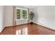 Bedroom bathed in light from a double window, complemented by polished wood floors and neutral walls at 11838 W Arlington Dr, Littleton, CO 80127