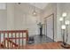 Bright foyer featuring wood floors and an elegant staircase leading to the upper level at 11838 W Arlington Dr, Littleton, CO 80127