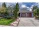 Charming single-Gathering home featuring a two-car garage, lush landscaping, and classic architectural details at 11838 W Arlington Dr, Littleton, CO 80127