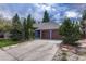 Charming single-Gathering home featuring a two-car garage, lush landscaping, and classic architectural details at 11838 W Arlington Dr, Littleton, CO 80127