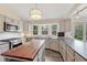 Modern kitchen with a central island, stainless steel appliances, and lots of windows at 11838 W Arlington Dr, Littleton, CO 80127