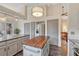 Spacious kitchen featuring stainless steel appliances, a center island, and neutral color palette at 11838 W Arlington Dr, Littleton, CO 80127