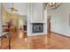 Bright living room featuring hardwood floors, a fireplace, and an open layout, perfect for entertaining and relaxation at 11838 W Arlington Dr, Littleton, CO 80127