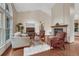 Cozy living room with a fireplace, large windows, and comfortable seating arrangement at 11838 W Arlington Dr, Littleton, CO 80127