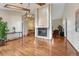 Open living room featuring hardwood floors, a fireplace, and views of other living spaces at 11838 W Arlington Dr, Littleton, CO 80127