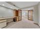 Finished office space with built-in shelves, cabinets, and desk at 11838 W Arlington Dr, Littleton, CO 80127