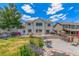 Large backyard with a patio, outdoor kitchen, pond, play set and a well maintained lawn at 11256 Lima St, Commerce City, CO 80640
