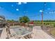 Backyard patio features a table set with an umbrella, barbecue, and outdoor seating with scenic views at 11256 Lima St, Commerce City, CO 80640