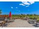Spacious backyard patio featuring a stone waterfall, lounge chairs, and serene open views at 11256 Lima St, Commerce City, CO 80640