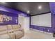 Finished basement featuring a large screen and comfortable seating for a home theater experience at 11256 Lima St, Commerce City, CO 80640