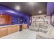 Finished basement with a wet bar, seating, and entertainment area for relaxing or entertaining at 11256 Lima St, Commerce City, CO 80640