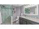 Updated bathroom featuring a glass-enclosed shower, modern vanity, and stylish finishes at 11256 Lima St, Commerce City, CO 80640