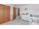 Light-filled Bedroom with a crib, closet, dresser, and a view of the backyard at 11256 Lima St, Commerce City, CO 80640