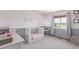 Bright and airy Bedroom with soft colors, a crib, and a window view of the backyard at 11256 Lima St, Commerce City, CO 80640