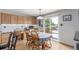 Bright dining area with wood floors, granite counters, and sliding glass doors to an outdoor deck at 11256 Lima St, Commerce City, CO 80640