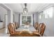 Formal dining room with a large window, elegant chandelier, and ornate chairs around the table at 11256 Lima St, Commerce City, CO 80640