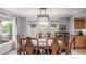Dining room featuring an ornate wooden table with chairs, a modern light fixture, and natural light at 11256 Lima St, Commerce City, CO 80640