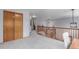 Upstairs hallway with gray carpet leading to bedrooms and other areas in this lovely home at 11256 Lima St, Commerce City, CO 80640