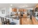 A well-appointed kitchen featuring a large island with granite countertops and wood cabinets at 11256 Lima St, Commerce City, CO 80640