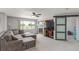 Cozy living room with a large sectional sofa, fireplace, and sliding barn door to another room at 11256 Lima St, Commerce City, CO 80640
