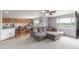 Open-concept living area with a sectional sofa connecting to the kitchen and dining spaces at 11256 Lima St, Commerce City, CO 80640