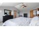 Spacious main bedroom with vaulted ceilings, ceiling fan, and ensuite bathroom access at 11256 Lima St, Commerce City, CO 80640