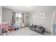 Bright playroom with neutral walls, play furniture, a sofa, and ample natural light at 11256 Lima St, Commerce City, CO 80640
