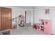 Spacious playroom featuring a dollhouse, kitchen set, and plenty of room for activities at 11256 Lima St, Commerce City, CO 80640
