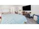 Bright bedroom featuring a bed, crib, desk, and mounted television at 16423 Mountain Flax Dr, Monument, CO 80132