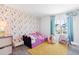 Charming bedroom with floral wallpaper, a cozy bed, and natural light at 16423 Mountain Flax Dr, Monument, CO 80132