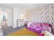 Bedroom with wallpaper, large bed, and an adjacent closet and other rooms at 16423 Mountain Flax Dr, Monument, CO 80132