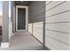 Inviting gray front porch featuring a dark front door and stylish siding at 16423 Mountain Flax Dr, Monument, CO 80132