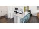 Bright, modern kitchen with a large island, white cabinets, and stainless steel appliances at 16423 Mountain Flax Dr, Monument, CO 80132