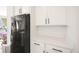 Kitchen with black appliances and white cabinets showcasing ample counter space and sleek design at 16423 Mountain Flax Dr, Monument, CO 80132