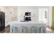 Bright kitchen featuring white cabinets, stainless steel appliances, and a large central island with seating at 16423 Mountain Flax Dr, Monument, CO 80132