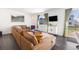 Comfortable living room featuring a large sectional sofa, bright windows, and modern decor at 16423 Mountain Flax Dr, Monument, CO 80132