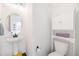 Stylish powder room featuring a pedestal sink, modern fixtures, and ample storage at 16423 Mountain Flax Dr, Monument, CO 80132