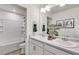 Bathroom features a double vanity with framed mirror, and shower at 779 N Deer Park St, Watkins, CO 80137