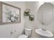 Stylish powder room with modern fixtures, framed art, vanity with white sink and decorative plant wall hangings at 779 N Deer Park St, Watkins, CO 80137