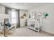 Bedroom with crib, rocking chair, and mountain-themed décor at 779 N Deer Park St, Watkins, CO 80137