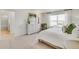 Bright and airy bedroom featuring a plush bed, dresser, green accent pillows, and soothing natural light at 779 N Deer Park St, Watkins, CO 80137