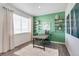 Bright dining area with a large window, unique decor, and hardwood floors at 779 N Deer Park St, Watkins, CO 80137