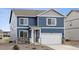 Charming two-story home with a mix of blue siding and stone accents at 779 N Deer Park St, Watkins, CO 80137