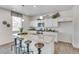 Bright kitchen with granite countertops, white cabinetry, pendant lighting and bar stool seating at the island at 779 N Deer Park St, Watkins, CO 80137