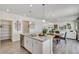 Open kitchen with granite countertops, stainless appliances and a view to the living and dining spaces at 779 N Deer Park St, Watkins, CO 80137