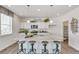 Bright kitchen with granite countertops, white cabinetry, stainless appliances, and a kitchen island with bar stools at 779 N Deer Park St, Watkins, CO 80137