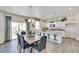 Dining area with an island kitchen, comfortable seating, and modern appliances at 779 N Deer Park St, Watkins, CO 80137