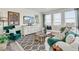 Cozy living room with a large sectional sofa, contemporary decor, and a plush rug at 779 N Deer Park St, Watkins, CO 80137