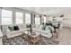 Open-concept living room with plush sofa, modern decor, and lots of natural light at 779 N Deer Park St, Watkins, CO 80137
