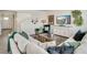 Comfortable living room featuring a sofa, stylish decor, and a modern entertainment center at 779 N Deer Park St, Watkins, CO 80137